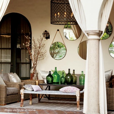 Collection of mirrors in an outdoor space via Style at Home | Design by Lara McGraw | Photo by Donna Griffith