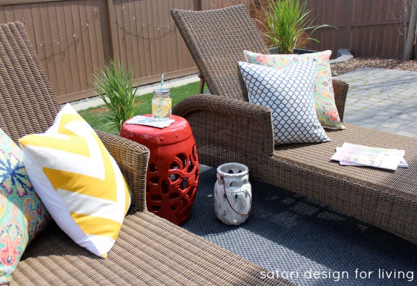 Outdoor Living Space with Wicker Lounge Chairs, Red Garden Stool and Yellow Chevron Pillow