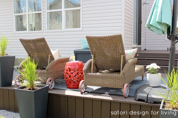 Outdoor Living Space with Wicker Loungers, Aqua Umbrella and Red Garden Stool