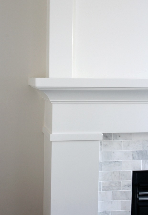 White Painted Fireplace Mantel with Marble Subway Tile Surround 