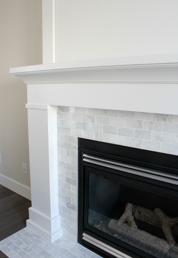 White Painted Fireplace with Marble Subway Tile 