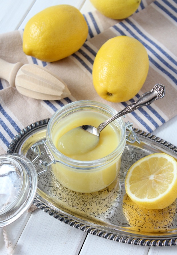 Homemade Lemon Curd in Jar with Lemons on Tea Towel