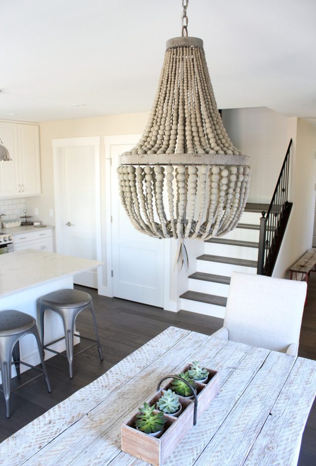 Wood Beaded Chandelier Over Whitewashed Table