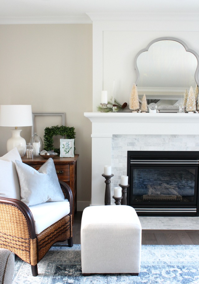 White and Marble Fireplace Decorated for the Holidays with Bottle Brush Trees and Antique Grey Mirror