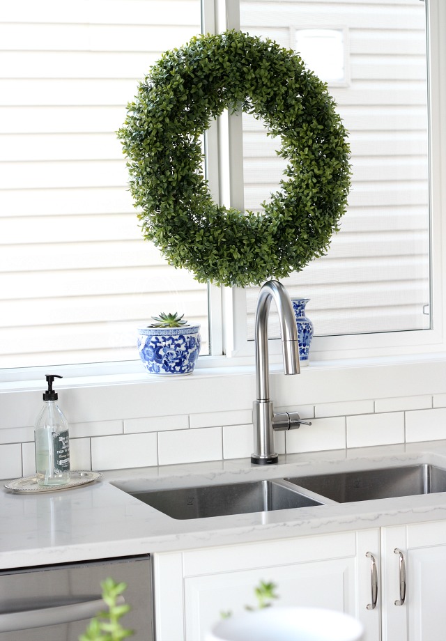 Boxwood Wreath Hung from the Kitchen Window for Christmas