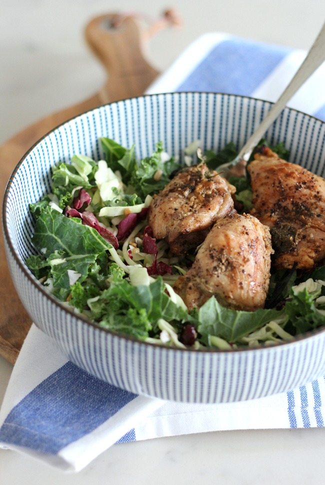 Grilled Chicken Kale Salad in Blue and White Bowl on Wood Serving Board