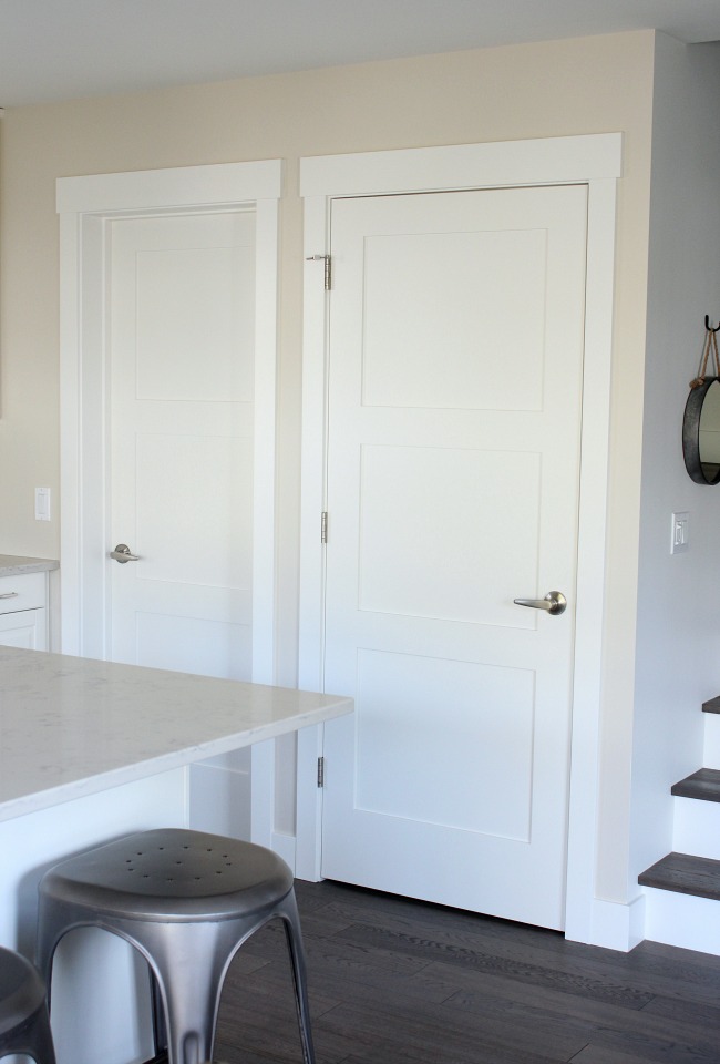 White 3 Panel Shaker Style Doors in the Kitchen with White Oak Floors