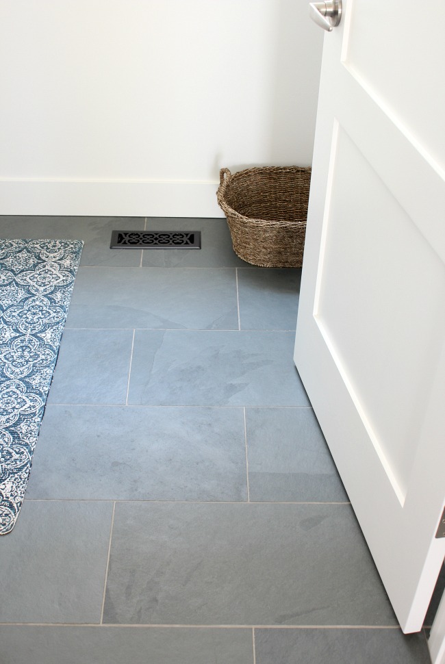 White Shaker Style Baseboards and 3-Panel Door in the Laundry Room with Brazilian Slate Floor 