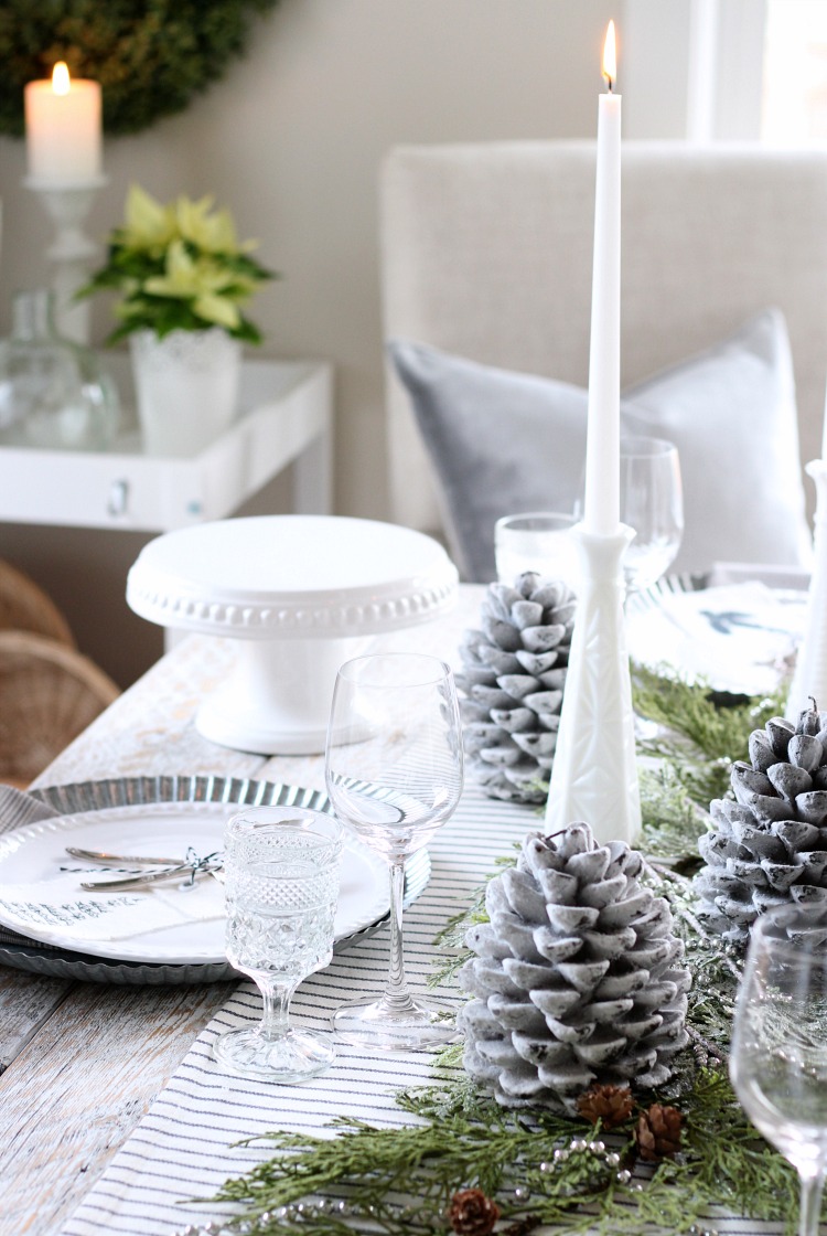 Winter White Christmas Table Setting with Pine Cone Candles and Greenery 