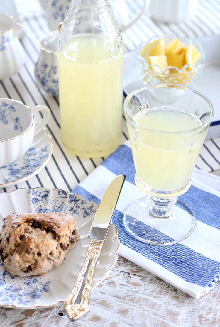 Homemade Lemonade in Glass Bottle and Scones on Blue and White Dessert Plate