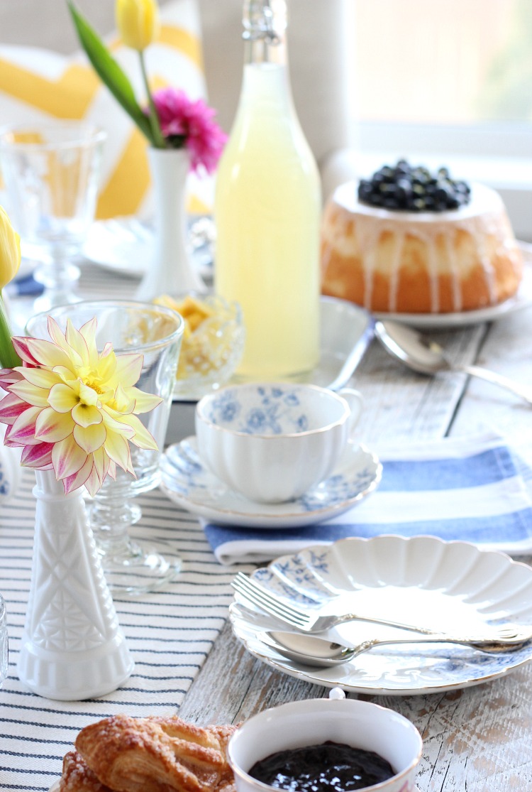 Afternoon Tea Table Setting with Blue and White Tea Set and Yellow Flowers