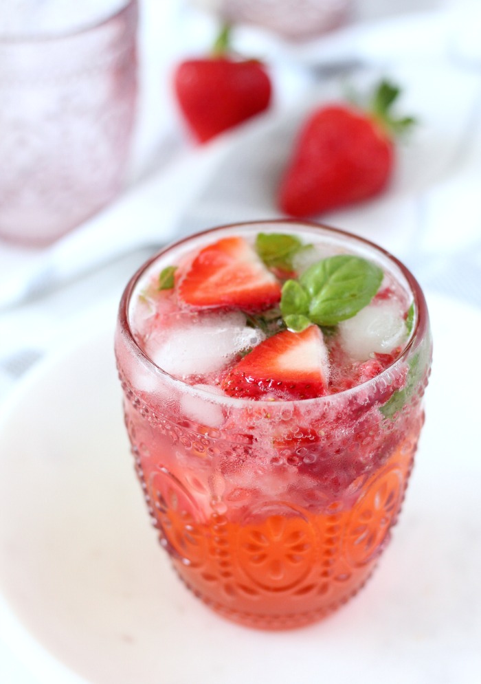 Summer Drink Made with Honey, Strawberries and Basil in Pink Glass