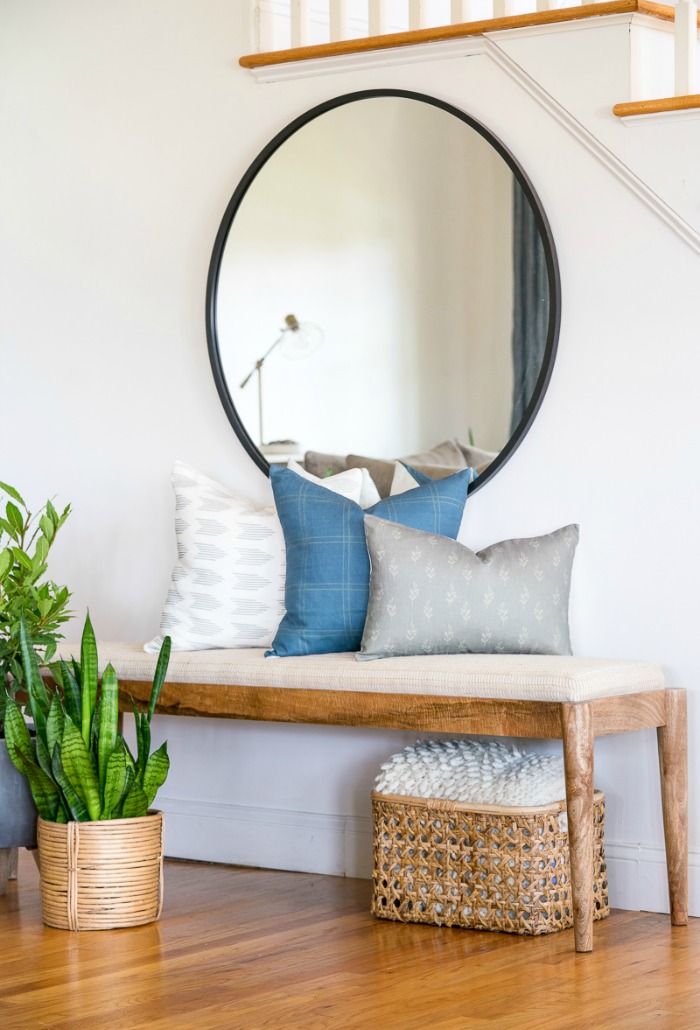 Pillows on Bench from City Farmhouse and Co. with Round Mirror Above