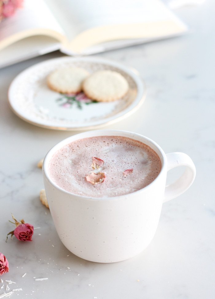 Homemade Pink Hot Chocolate for Valentine's Day in White Mug Topped with Dried Rose Petals