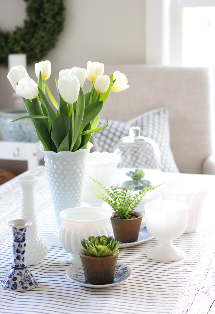 Spring Table Centerpiece with Potted Plants and Milk Glass Vases