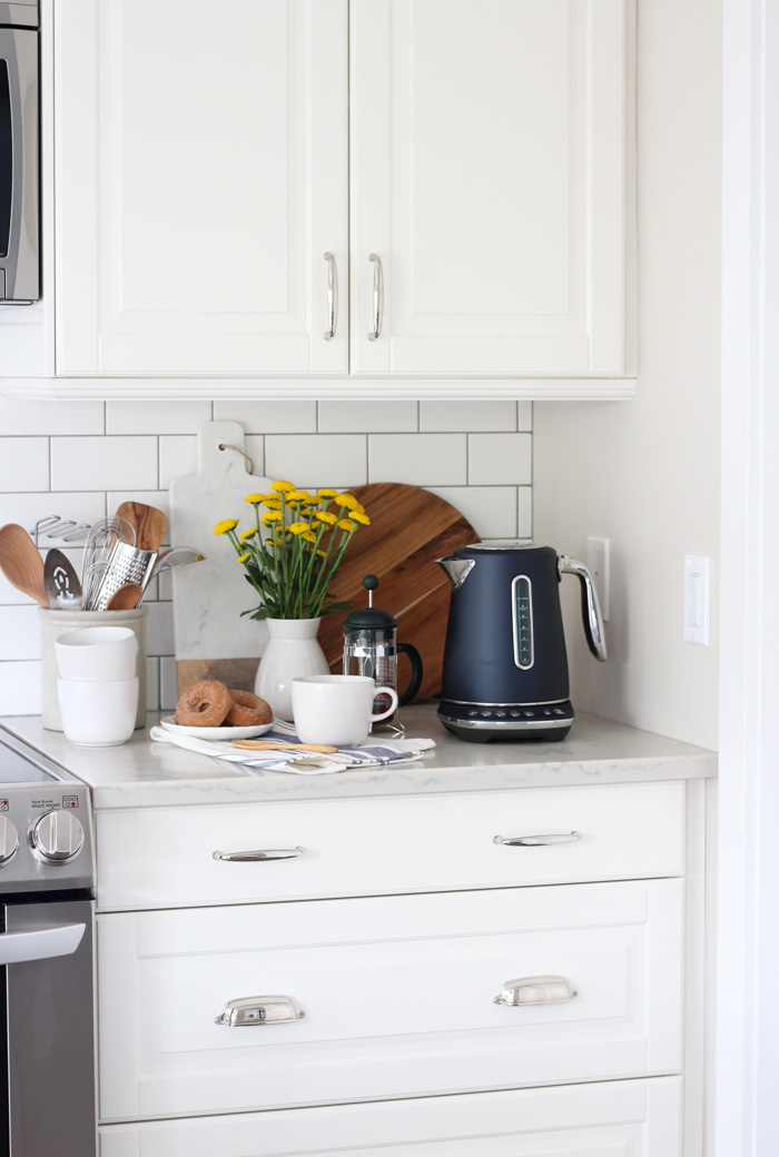 Breville Blue Kettle in White Kitchen with Coffee Cup and Donuts