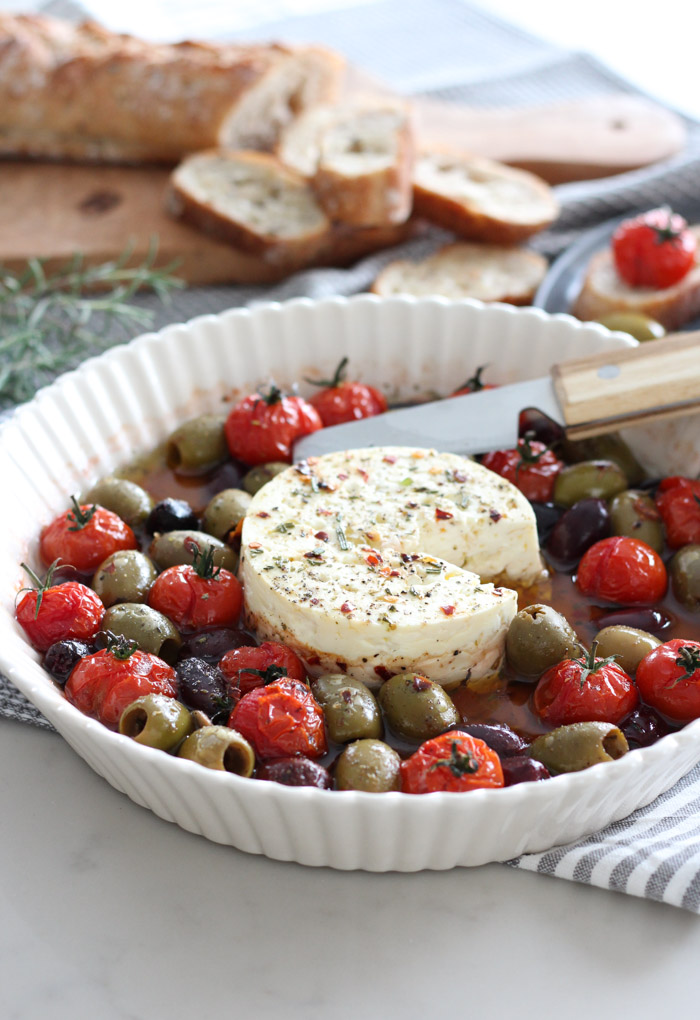 Baked Feta with Tomatoes and Olives in White Dish