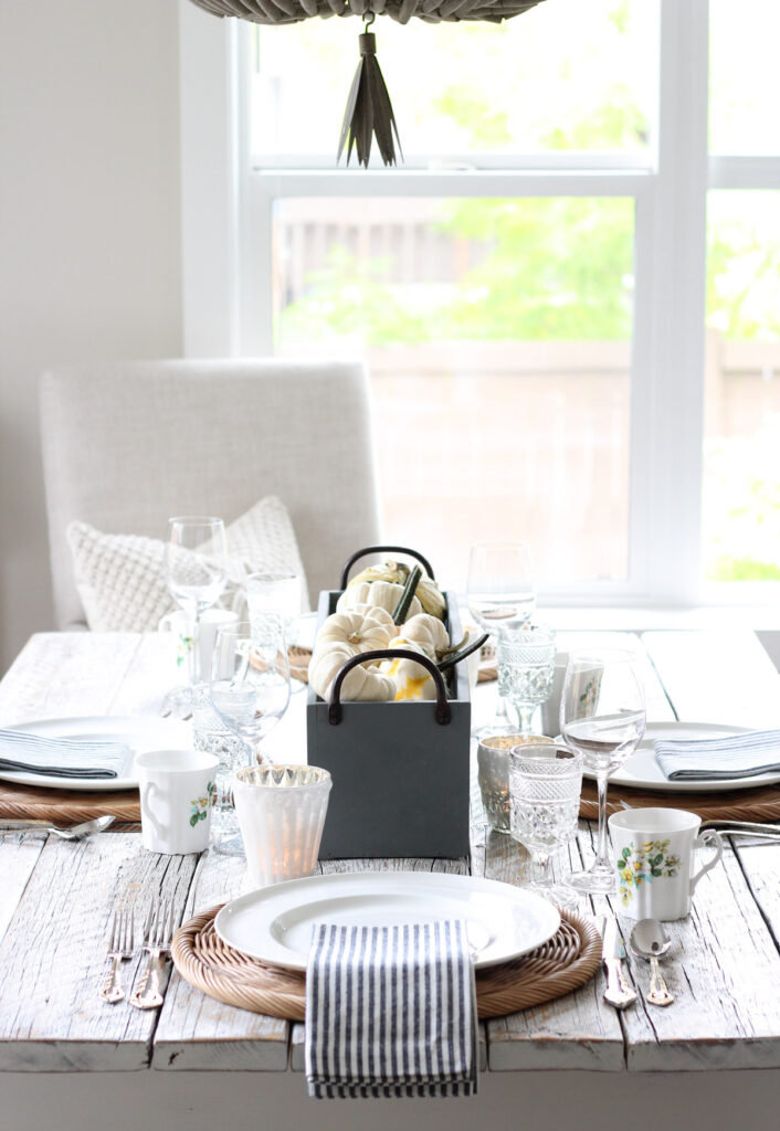 Neutral Fall Table Setting with Pumpkin Centerpiece and White Floral Mugs