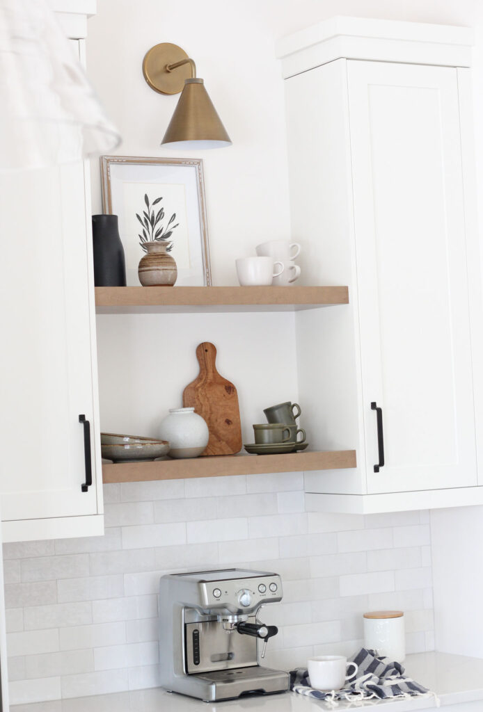 Brass Sconce Above Wood Shelves in Kitchen