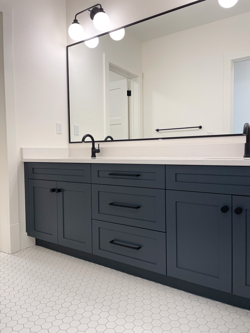 Modern Vintage Bathroom with Dark Navy Cabinets, Matte Black Hardware and White Quartz Countertop