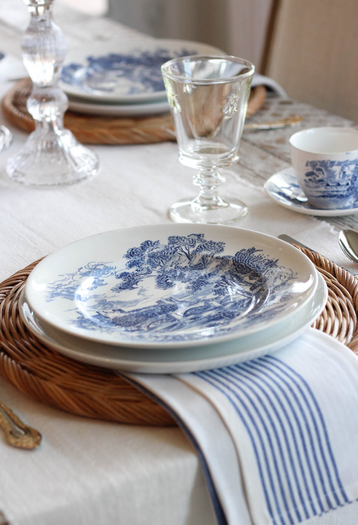 Layered tablescape with blue and white Wedgwood plates and tea cups